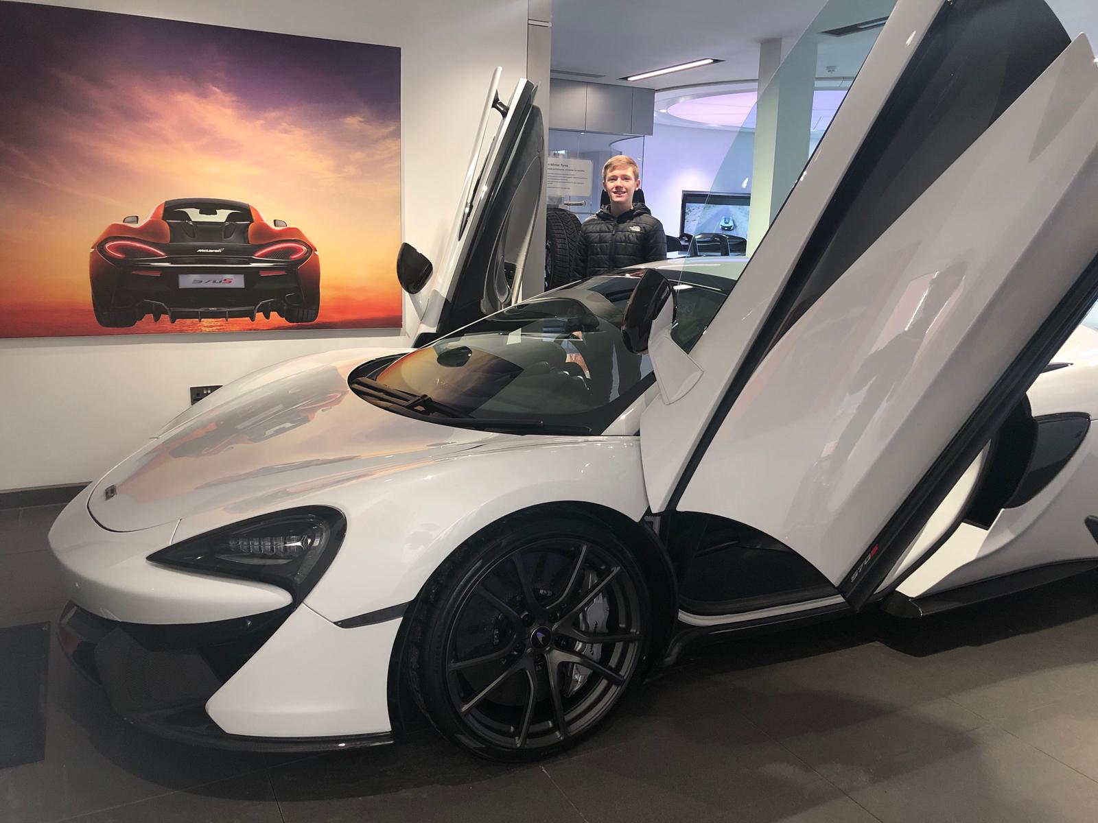 White McLaren 570S Spyder with both dihedral doors open